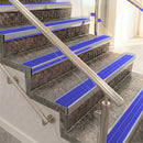 Raked back aluminium stair nosing, mill aluminium with mid blue castellated insert