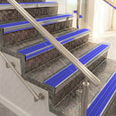 Raked back aluminium stair nosing, polished aluminium with mid blue castellated insert