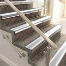 Raked back aluminium stair nosing, polished aluminium with polar grey smooth textured insert