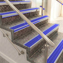 Raked back aluminium stair nosing, satin aluminium with mid blue castellated insert