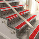 Raked back aluminium stair nosing, satin aluminium with poppy castellated insert