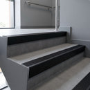 Black Anodised raked back aluminium stair nosing 62x55mm with Black Anodised Aluminium infill, fitted to a concrete step