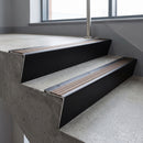 Black Anodised raked back aluminium stair nosing 62x55mm with Bronze Aluminium infill, fitted to a concrete step