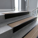 Black Anodised raked back aluminium stair nosing 62x55mm with Fawn Castellated infill, fitted to a concrete step