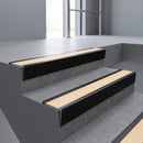 Black Anodised raked back aluminium stair nosing 62x55mm with Ivory Castellated infill, fitted to a concrete step
