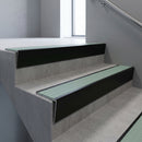 Black Anodised raked back aluminium stair nosing 62x55mm with Jade Castellated infill, fitted to a concrete step