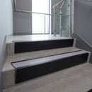 Black Anodised raked back aluminium stair nosing 62x55mm with Nimbus Castellated infill, fitted to a concrete step