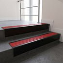 Black Anodised raked back aluminium stair nosing 62x55mm with Poppy Castellated infill, fitted to a concrete step