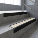 Black Anodised raked back aluminium stair nosing 62x55mm with Porth Stone Castellated infill, fitted to a concrete step