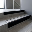 Black Anodised raked back aluminium stair nosing 62x55mm with Satin Aluminium infill, fitted to a concrete step