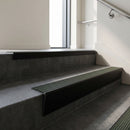 Black Anodised raked back aluminium stair nosing 62x55mm with Spruce Castellated infill, fitted to a concrete step