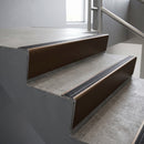 Bronze raked back aluminium stair nosing 62x55mm with Black Anodised Aluminium infill, fitted to a concrete step