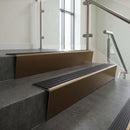 Bronze raked back aluminium stair nosing 62x55mm with Black Castellated infill, fitted to a concrete step