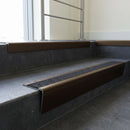 Bronze raked back aluminium stair nosing 62x55mm with Black Olympic Grip infill, fitted to a concrete step