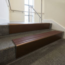 Bronze raked back aluminium stair nosing 62x55mm with Claret Castellated infill, fitted to a concrete step