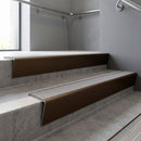 Bronze raked back aluminium stair nosing 62x55mm with Flint Castellated infill, fitted to a concrete step