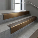 Bronze raked back aluminium stair nosing 62x55mm with Granite Castellated infill, fitted to a concrete step