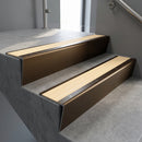Bronze raked back aluminium stair nosing 62x55mm with Ivory Castellated infill, fitted to a concrete step
