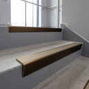 Bronze raked back aluminium stair nosing 62x55mm with Light Bronze Aluminium infill, fitted to a concrete step