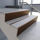 Bronze raked back aluminium stair nosing 62x55mm with Light Grey Castellated infill, fitted to a concrete step