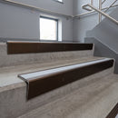 Bronze raked back aluminium stair nosing 62x55mm with Light Grey Smooth Textured infill, fitted to a concrete step