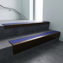 Bronze raked back aluminium stair nosing 62x55mm with Mid Blue Castellated infill, fitted to a concrete step