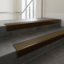 Bronze raked back aluminium stair nosing 62x55mm with Olive Castellated infill, fitted to a concrete step