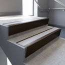 Bronze raked back aluminium stair nosing 62x55mm with Polar Grey Smooth Textured infill, fitted to a concrete step