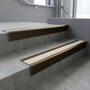 Bronze raked back aluminium stair nosing 62x55mm with Porth Stone Castellated infill, fitted to a concrete step