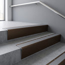 Bronze raked back aluminium stair nosing 62x55mm with Satin Aluminium infill, fitted to a concrete step