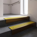 Bronze raked back aluminium stair nosing 62x55mm with Yellow Castellated infill, fitted to a concrete step