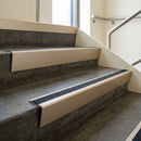 Light Bronze raked back aluminium stair nosing 62x55mm with Black Olympic Grip infill, fitted to a concrete step