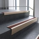 Light Bronze raked back aluminium stair nosing 62x55mm with Claret Castellated infill, fitted to a concrete step