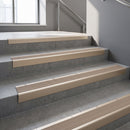 Light Bronze raked back aluminium stair nosing 62x55mm with Fawn Castellated infill, fitted to a concrete step