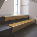 Light Bronze raked back aluminium stair nosing 62x55mm with Gold Castellated infill, fitted to a concrete step