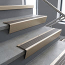 Light Bronze raked back aluminium stair nosing 62x55mm with Granite Castellated infill, fitted to a concrete step
