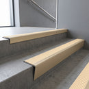 Light Bronze raked back aluminium stair nosing 62x55mm with Ivory Castellated infill, fitted to a concrete step