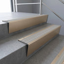 Light Bronze raked back aluminium stair nosing 62x55mm with Light Grey Castellated infill, fitted to a concrete step