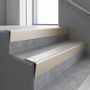 Light Bronze raked back aluminium stair nosing 62x55mm with Mill Aluminium infill, fitted to a concrete step