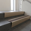 Light Bronze raked back aluminium stair nosing 62x55mm with Peat Castellated infill, fitted to a concrete step