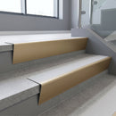 Light Bronze raked back aluminium stair nosing 62x55mm with Polar Grey Smooth Textured infill, fitted to a concrete step