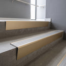 Light Bronze raked back aluminium stair nosing 62x55mm with Polished Aluminium infill, fitted to a concrete step