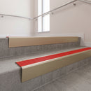 Light Bronze raked back aluminium stair nosing 62x55mm with Poppy Castellated infill, fitted to a concrete step