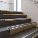 Light Bronze raked back aluminium stair nosing 62x55mm with Regency Castellated infill, fitted to a concrete step