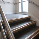 Light Bronze raked back aluminium stair nosing 62x55mm with Rustic Castellated infill, fitted to a concrete step