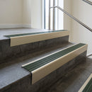 Light Bronze raked back aluminium stair nosing 62x55mm with Spruce Castellated infill, fitted to a concrete step