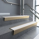 Light Bronze raked back aluminium stair nosing 62x55mm with White Castellated infill, fitted to a concrete step