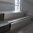 Mill Aluminium raked back aluminium stair nosing 62x55mm with Black Anodised Aluminium infill, fitted to a concrete step