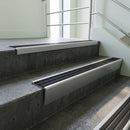 Mill Aluminium raked back aluminium stair nosing 62x55mm with Black Castellated infill, fitted to a concrete step