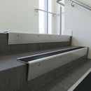 Mill Aluminium raked back aluminium stair nosing 62x55mm with Black Smooth Textured infill, fitted to a concrete step
